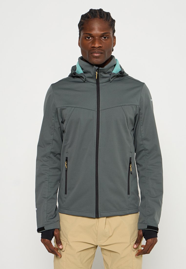 Veste softshell grise avec capuche, présentant des accents teal et des zip noirs. Deux poches latérales zippées et un design élégant et ajusté.