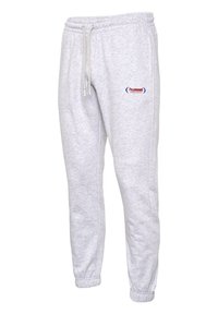 Grau Sweatpants aus weichem Material, mit elastischem Bund und Kordelzug sowie einem kleinen Logo an der Seite. Schmal zulaufendes Bein-Design.