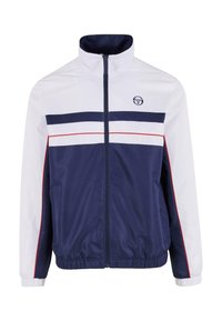 Marineblå og hvit zip-up jakke med elastiske mansjetter og kant. Har horisontale striper i marineblå og rød. Logo på øvre venstre side. Glatt, strukturert stoff.