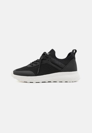 Black athletic shoes with mesh upper, round toe, lightweight white sole, and black laces. Features a padded collar and subtle side accents.