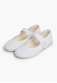 Weiße Kanvas Mary Jane Schuhe mit flacher Sohle, runder Zehenpartie und einem Riemen über dem Spann, der mit einem Knopfdetail gesichert ist.