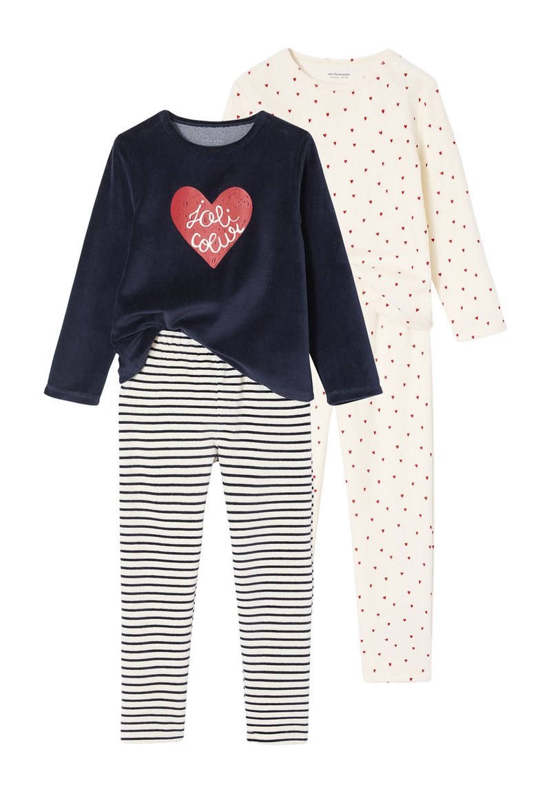 Two sets of children's pajamas: a navy top with a red heart design and striped bottoms, and an off-white top with red heart patterns and matching pants.