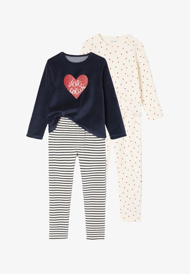 Two sets of children's pajamas: a navy top with a red heart design and striped bottoms, and an off-white top with red heart patterns and matching pants.