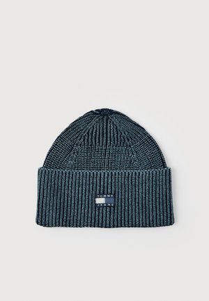 Ribbed knit beanie in two-tone blue with folded cuff and a rectangular "Tommy Jeans" logo patch on the front.