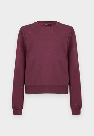 Felpa crewneck bordeaux con piccoli motivi a forma di cuore discreti, polsini e orlo a coste, mostrata su uno sfondo neutro.