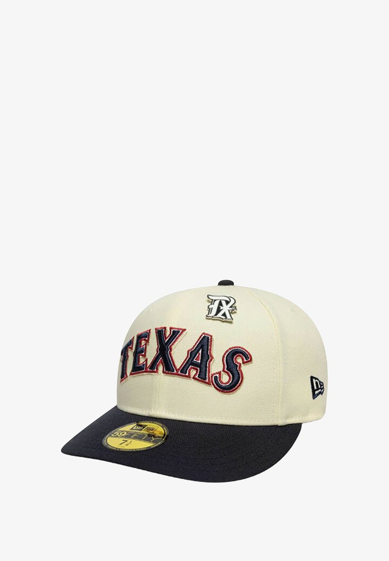 Beige baseball cap with a navy brim, featuring "TEXAS" in red embroidered letters and a metallic logo on the front. New Era tag visible.