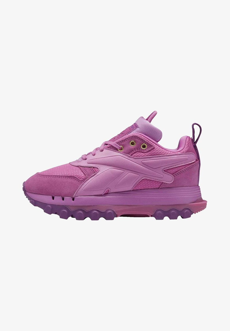 Baskets de sport violettes avec dessus en mesh texturé et en suède, semelle rembourrée, laçage sur l'avant et languette au talon.