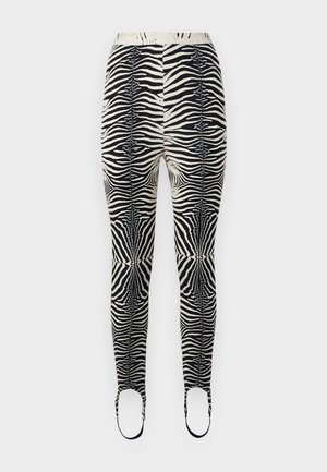 Leggings à imprimé zèbre avec une palette de couleurs noire et beige, en matériau extensible, taille haute et ouvertures pour les pieds avec des sangles.