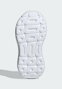 White sneaker sole with textured grip pattern, featuring a raised, geometric design and a rounded toe. Light, flexible material.