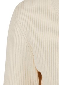 Ribbat stickad tröja i en krämfärg, med vertikala ränder, en mjuk textur och design med V-ringning. Detaljer inkluderar förstärkta sömmar.
