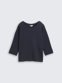 Navy blue, boxy top featuring a textured fabric, subtle seam detail, and dropped shoulders, with three-quarter length sleeves.