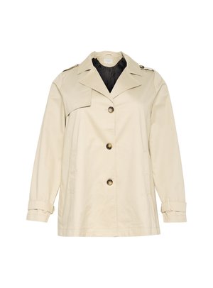 Manteau beige avec un design structuré, featuring un large col, de gros boutons frontaux et des poignets. Il a des poches latérales et une texture lisse.