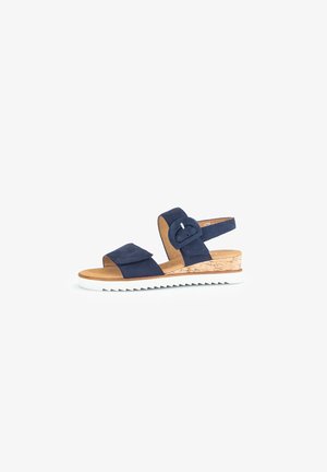 Navy blue suede sandal featuring two adjustable straps, cork-like wedge, white rubber sole, and a round buckle accent.