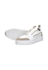 White sneakers with beige suede accents, textured rubber sole, standard lace closure, and perforated design for breathability.