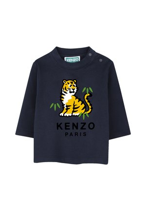 T-shirt bébé manches longues bleu marine avec motif tigre jaune et feuilles vertes, et texte noir "Kenzo Paris" à l'avant, boutons-pression à l'épaule.