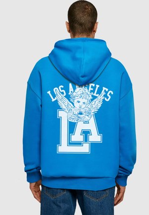 Blue hoodie featuring a large white graphic on the back with "LOS ANGELES" and an angelic figure. Soft fabric, relaxed fit, and kangaroo pocket.
