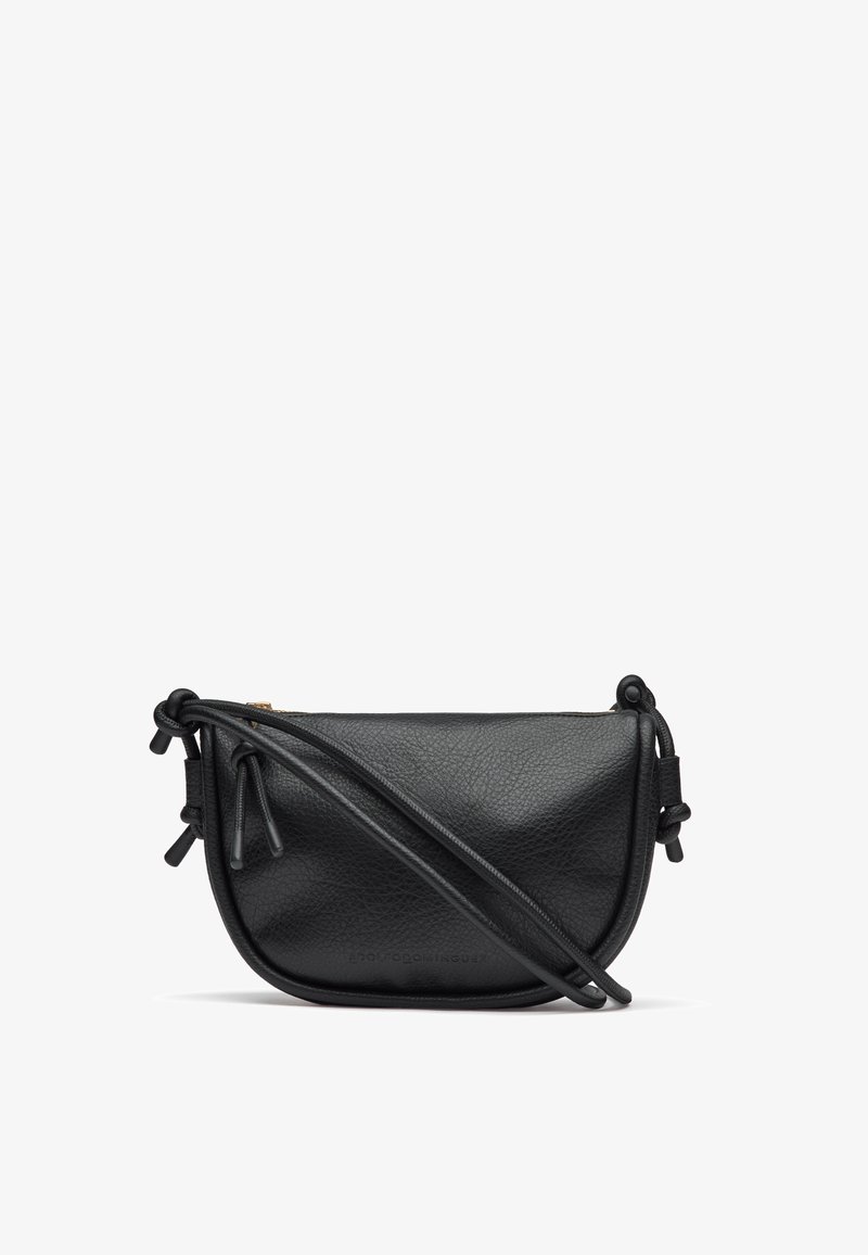 Borsa a tracolla in pelle nera con forma curva, finitura testurizzata, dettagli con coulisse ai lati e una tracolla sottile. Chiusura con zip sulla parte superiore.