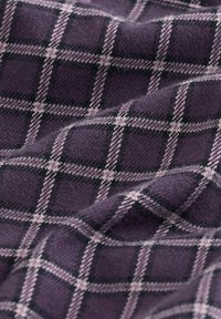 Lilla stof med et ternet mønster i sort og lys rosa. Texturen ser blød og lidt fuzzy ud.