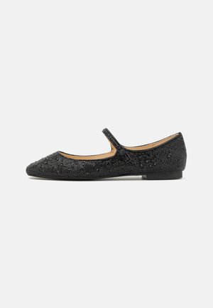 Black flat shoe with a pointed toe, textured upper adorned with small beads, and a side strap featuring a button closure. Low heel.