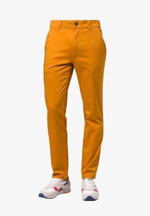 Slim-fit trousers in vibrant orange fabric, featuring a button and zipper front closure, side pockets, and sleek, smooth texture.