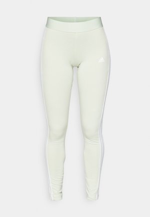 Light green leggings made of stretchy material, featuring white side stripes and an embroidered logo on the hip. Smooth texture, fitted design.
