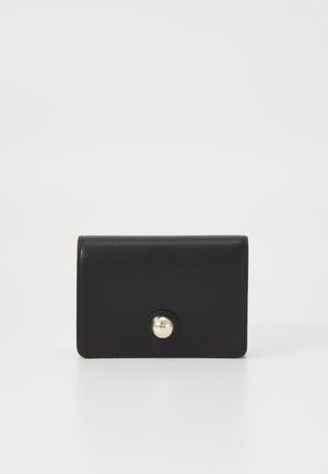 Black leather wallet with a smooth texture, rectangular shape, and a prominent gold button closure at the front. Minimalist design.