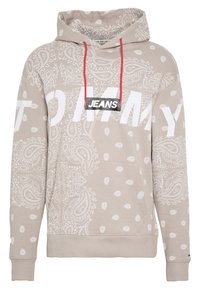 Felpa beige con motivo paisley, scritta bianca "TOMMY JEANS", coulisse rossa, tasca frontale e polsini e orlo a costine.