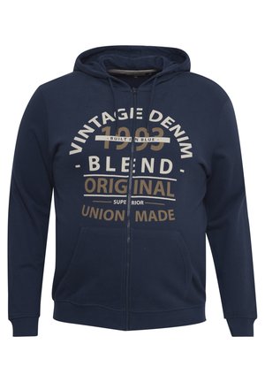 Laivaston sininen vetoketjuhuppari, joka on valmistettu pehmeästä kankaasta. Hupparissa on etutasku ja suuri graafinen teksti kermaisen ja kultaisen värin yhdistelmässä, jossa lukee "Vintage Denim 1993 Blend".