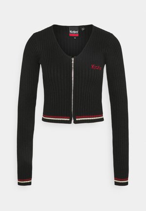 Black ribbed long-sleeve cardigan with front zipper, red and white trim on cuffs and hem, and red "Kickers" logo on left chest.