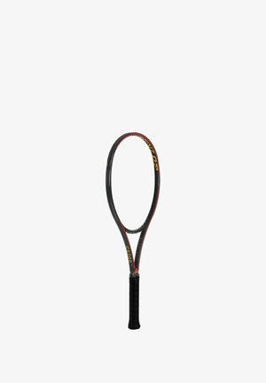 Black tennis racket with red accents, featuring a slightly elongated oval head, a black textured grip, and yellow branding on the frame.