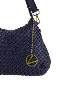 Navy woven leather handbag with a rounded shape, featuring a gold-tone chain and charm accent. Textured surface and durable strap.