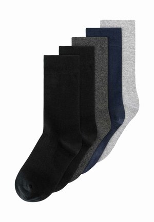 Five pairs of plain crew socks in black, dark gray, navy blue, and light gray, arranged overlapping from left to right.