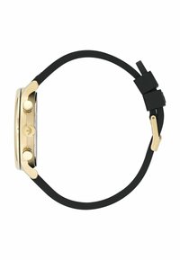 Montre dorée avec un boîtier rond, bracelet en caoutchouc noir, deux boutons poussoirs sur le côté et un détail de logo sur le cadran.