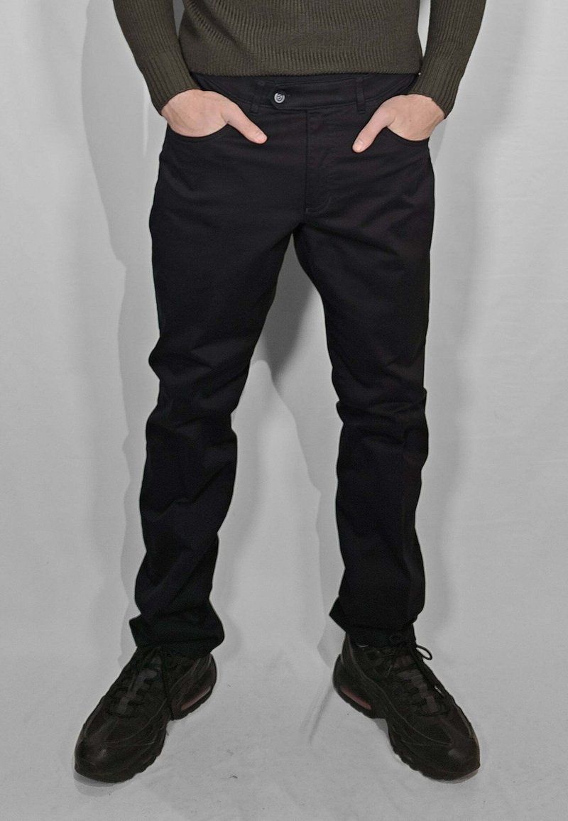 Pantaloni neri con design a gamba dritta, realizzati in un tessuto liscio. La vita ha una chiusura con bottone, con tasche ai lati.