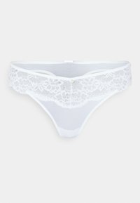 Balta tanga apakšveļa ar mežģīņu jostasvietu, kurai ir ziedu raksti un neliels dekoratīvs dārgakmens priekšā. Mīksta, caurspīdīga auduma.