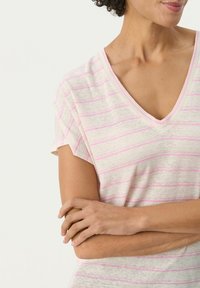 Lätt V-ringad t-shirt i krämfärgad med rosa ränder. Korta ärmar och mjuk textur med avslappnad passform. Enkel design som passar för vardagsbruk.