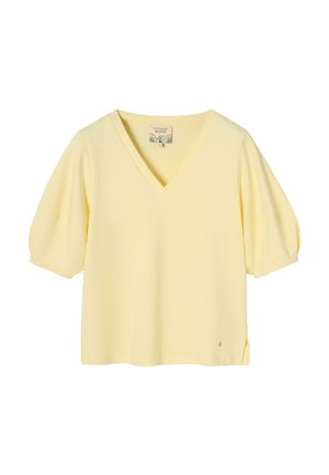 Šviesiai geltona trumpomis rankovėmis palaidinė su V formos iškirpte ir šiek tiek pūstomis rankovėmis, mažas šoninis plyšys, prekės ženklo etikėtė iškirptės viduje.