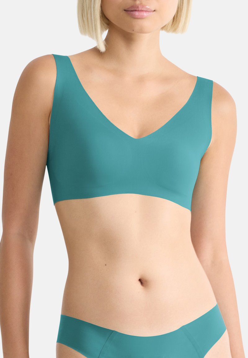 Turquoise seamless bralette with wide straps and a V-neck design. Made from smooth fabric, featuring no visible fastenings or embellishments.