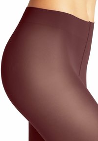 Leggings bordeaux con una finitura liscia e Trasparente, dotate di un alta vita e di un design aderente che si adatta alla gamba.