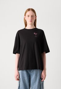 Black cotton t-shirt with short sleeves and a round neckline; features a pink embroidered cocktail glass design on the chest.