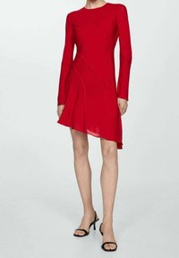Vestido largo rojo de manga larga con dobladillo asimétrico, hecho de un tejido ligero, que presenta costuras curvadas y un sencillo cuello redondo.