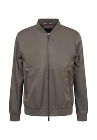 Braune, leichte Bomberjacke mit durchgehendem Reißverschluss, zwei Seitentaschen, gerippten Bündchen und Kragen. Glattes Material mit matter Oberfläche.