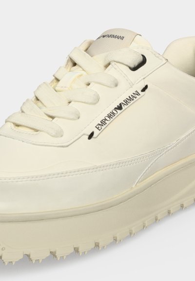Αθλητικό παπούτσι Emporio Armani σε κρεμ χρώμα με παχιά σόλα, υφή πάτου, σχέδιο με κορδόνια και ορατό λογότυπο της μάρκας στο πλάι και στη γλώσσα.