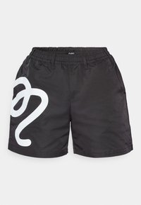 Black athletic shorts made of lightweight fabric, featuring an elastic waistband and a large white graphic design on the left leg.