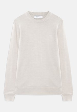 Vaaleanbeige pitkähihaisessa crewneck-neuleessa on röyhelökaulus ja -helma, hienovarainen logo vasemmassa rintapielessä ja J.Lindeberg -etiketti kauluksessa.