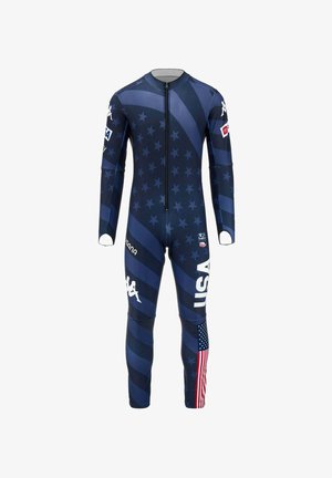 Completo tuta da sci blu scuro con stelle, strisce, testo USA, bandiera statunitense sulla gamba, loghi degli sponsor sulle braccia e sulle gambe, chiusura frontale con zip.