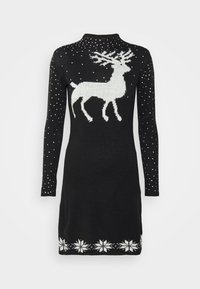 Svart stickad klänning med en vit ren design, spridda vita prickar och ett snöflinge mönster längs fållen. Långa ärmar ingår.