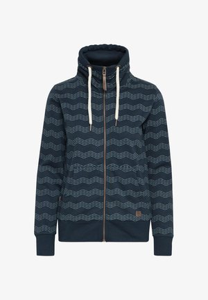 Marineblå zip-up hættetrøje med høj krave, hvide zigzag-mønstre, frontlommer og snoretræk. Fremstillet af blødt stof.