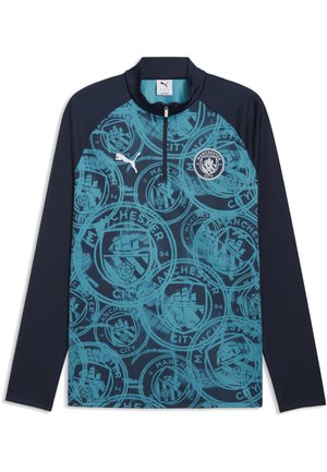 Sudadera de entrenamiento de manga larga de Manchester City de Puma en azul marino y verde azulado, con patrón repetido del escudo del club y cuello con cremallera de cuarto de longitud.