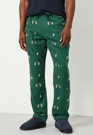 Green pants made of soft fabric featuring a patterned design of penguins. They have an elastic waistband with a drawstring and a straight leg fit.